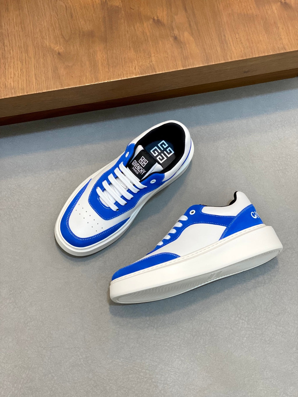 Blue and white low-top lace-up sneakers, top view of pair