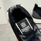 Heel view of black sneaker with Givenchy Paris label on the strap