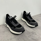 Black mesh sneakers with lace-up front and white midsole, side view