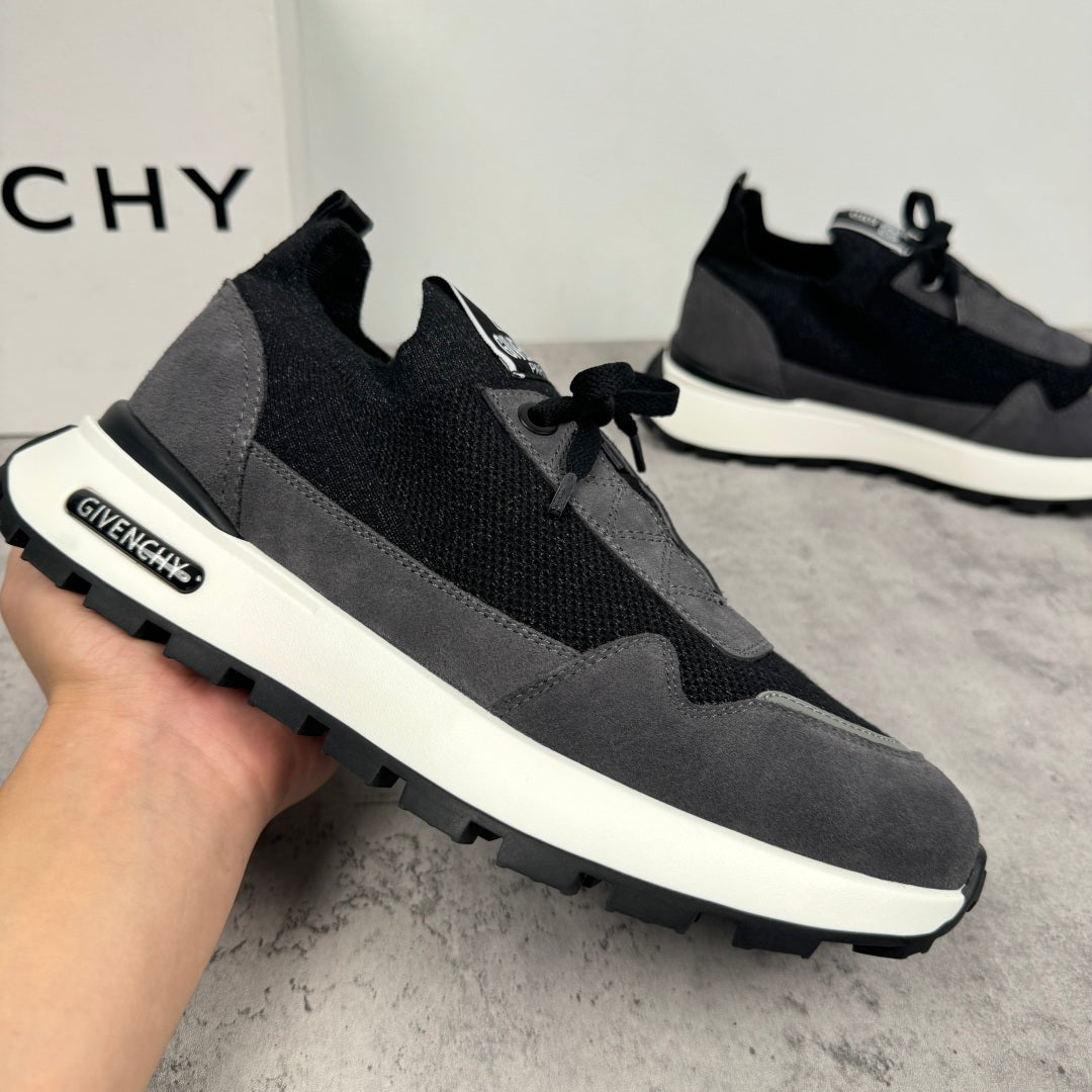 Black and dark gray lace-up sneakers with white sole and side brand patch