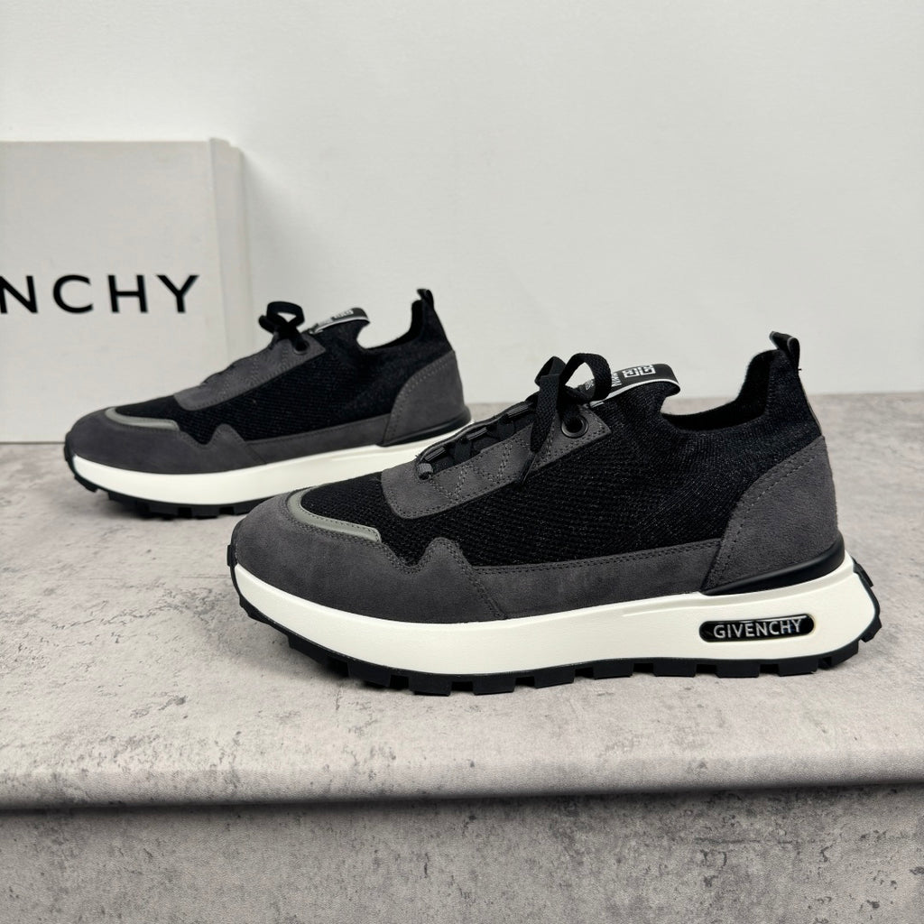 Dark lace-up sneakers with black upper, gray panels, and white sole