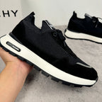 Black Givenchy knit sneakers with lace-up front and white treaded sole