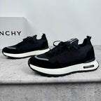 Black Givenchy low-top sneakers, front angle with lace-up closure and white midsole