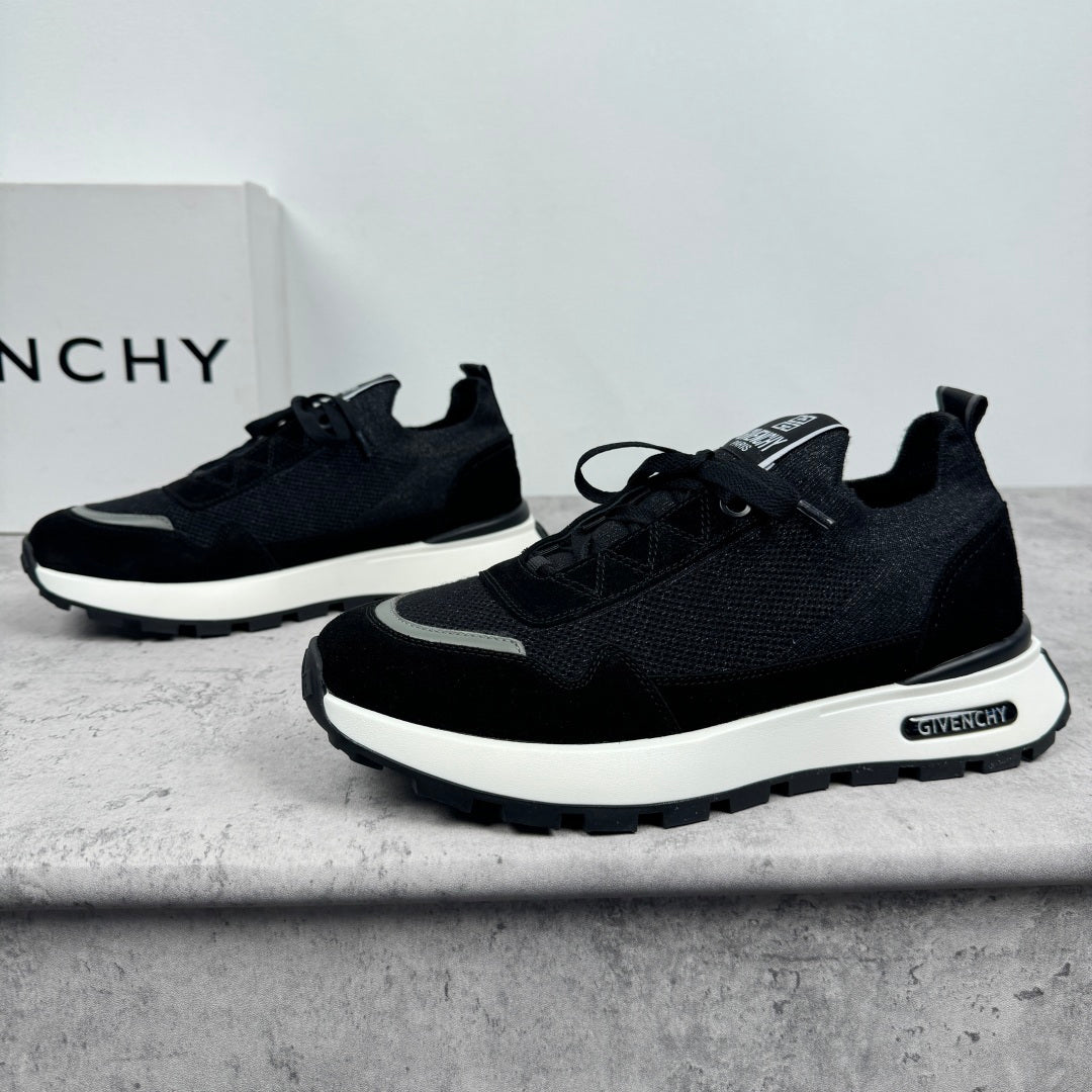 Black Givenchy low-top sneakers, front angle with lace-up closure and white midsole