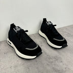 Black Givenchy low-top sneakers, side view with textured panels and white rubber sole