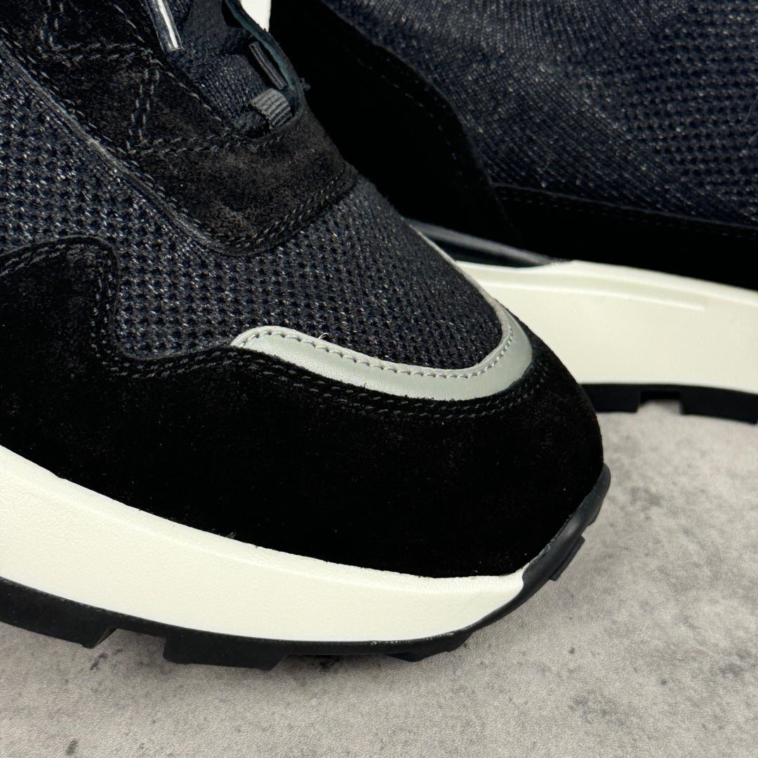 Black Givenchy sneakers with textured knit upper, dark toe panel, and white sole