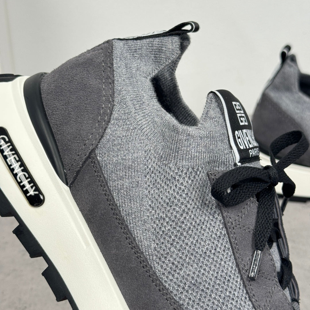 Givenchy sneakers side view: dark gray knit upper, black lace loops, white midsole