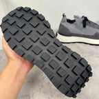 Givenchy sneakers tread outsole view with raised rubber blocks and dark gray finish