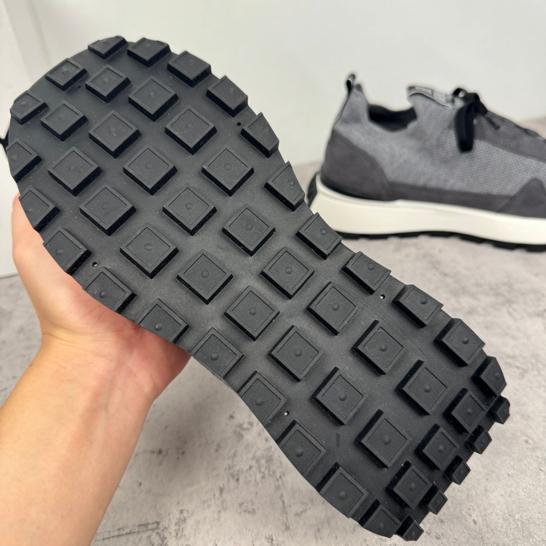 Givenchy sneakers tread outsole view with raised rubber blocks and dark gray finish