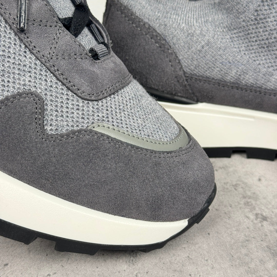 Givenchy sneakers close-up: gray mesh and suede panels with black laces and white sole