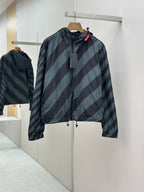 Hooded windbreaker jacket with diagonal striped pattern in dark blue and light blue