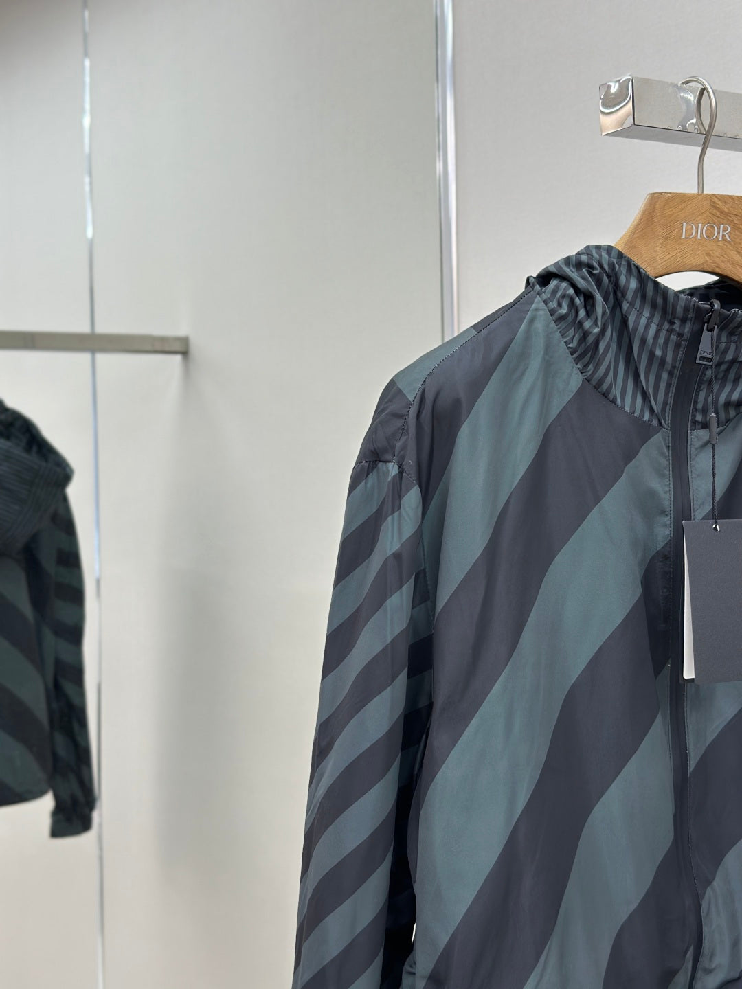 Hooded windbreaker jacket shoulder and hood area in dark blue and light blue stripes
