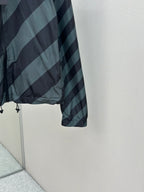 Hooded windbreaker jacket sleeve and side hem with adjustable drawstring