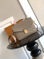 Louis Vuitton monogram crossbody bag in taupe with gold hardware and adjustable strap