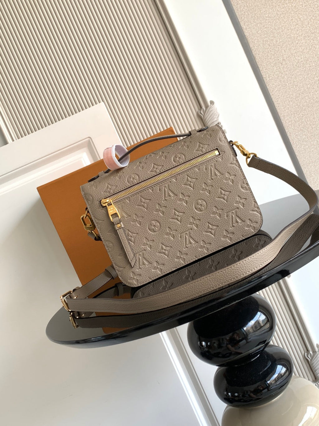 Louis Vuitton monogram crossbody bag in taupe, front view with flap and gold-tone clasp