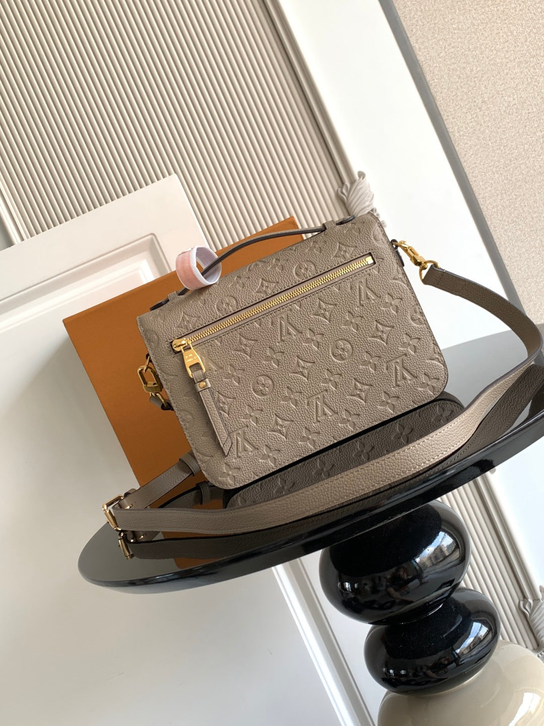 Louis Vuitton monogram crossbody bag in taupe, front view with flap and gold-tone clasp