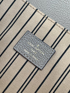 Louis Vuitton Paris label on striped fabric lining with gray text on light background
