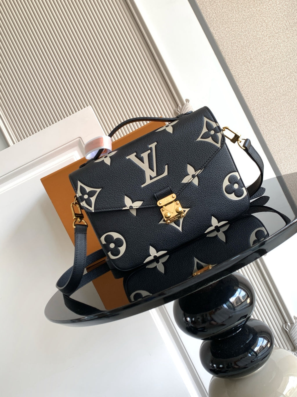 Louis Vuitton monogram crossbody bag in dark navy with gold hardware and shoulder strap.