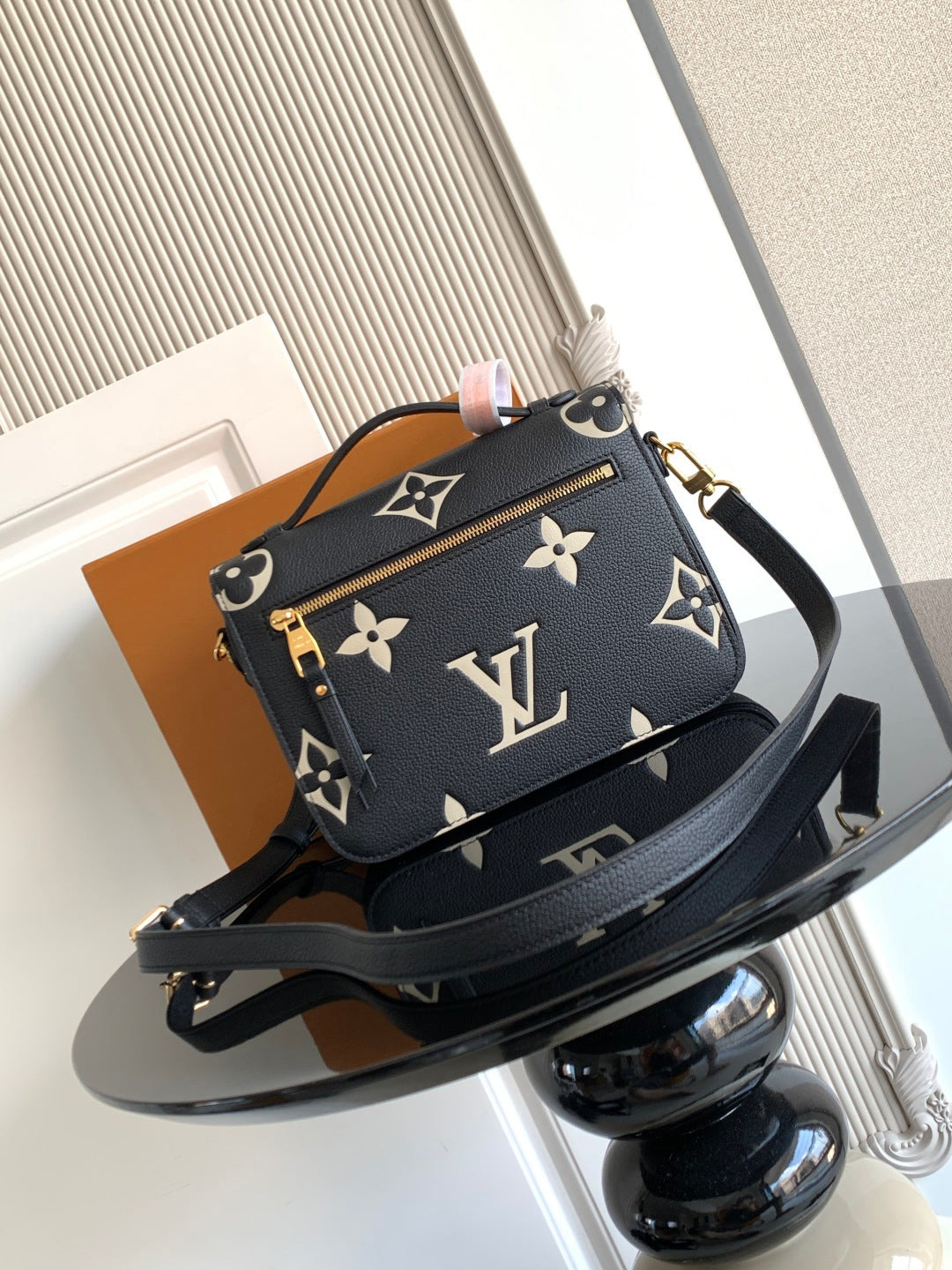 Louis Vuitton monogram crossbody bag, dark navy with gold hardware and top handle.