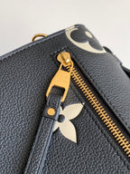 Louis Vuitton zipper pull and gold teeth on dark pebbled leather with monogram trim.