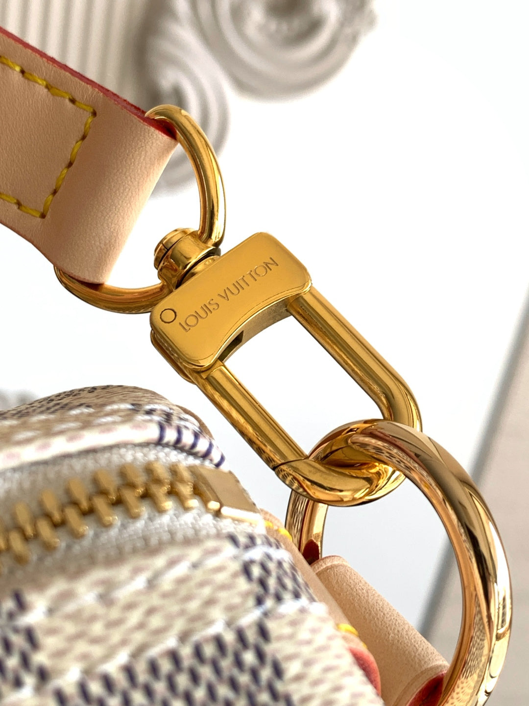 Louis Vuitton bag gold clasp key ring detail on tan leather strap