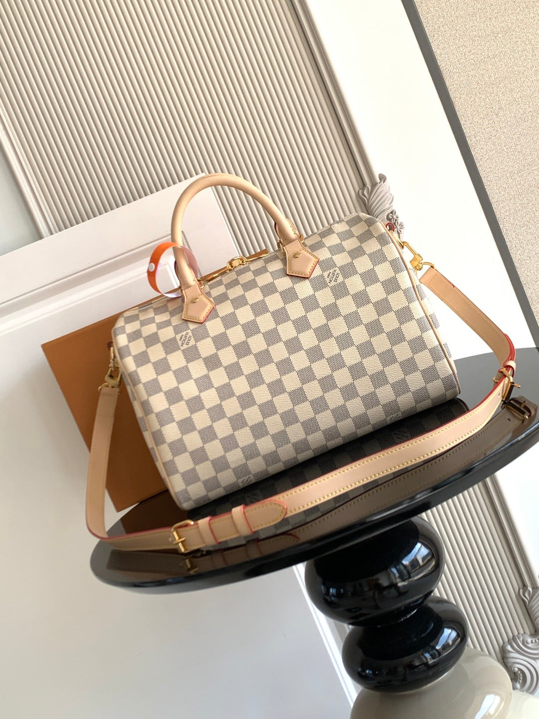 Louis Vuitton checkerboard top-handle bag with crossbody strap and tan trim