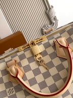 Louis Vuitton checkerboard bag with zipper hardware and structured top edge