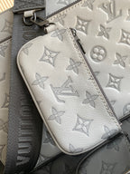 Louis Vuitton monogram pouch, light gray leather with zipper and logo pattern close-up.