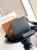 Louis Vuitton monogram shoulder bag, gray with black strap and logo hardware, front view.