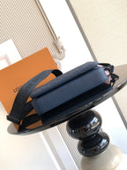 Dark blue crossbody bag with structured front panel and detachable strap
