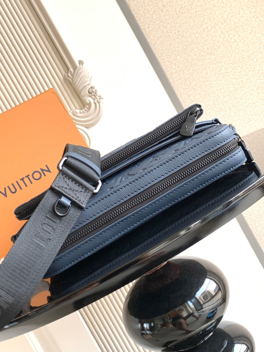 Dark blue crossbody bag with double zip compartments and adjustable strap