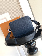 Dark blue crossbody bag with logo embossing and shoulder strap