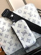 Crossbody bag with white base and light blue monogram, black crossbody strap