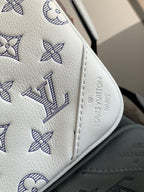 Louis Vuitton bag corner close-up with blue monogram flowers and embossed logo