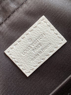 White leather logo patch with embossed Louis Vuitton lettering
