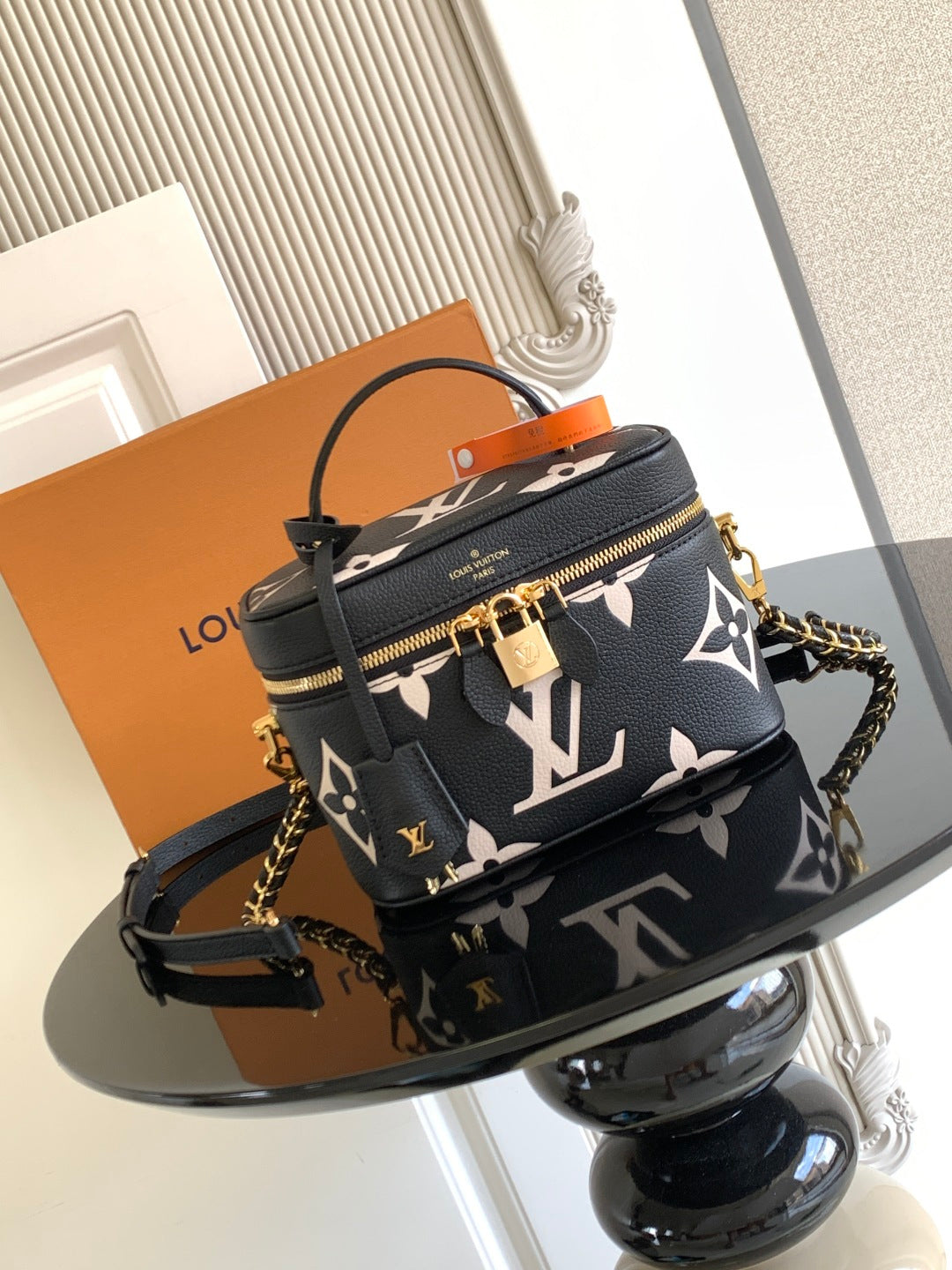 Louis Vuitton crossbody mini bag in black with white monogram and gold chain strap