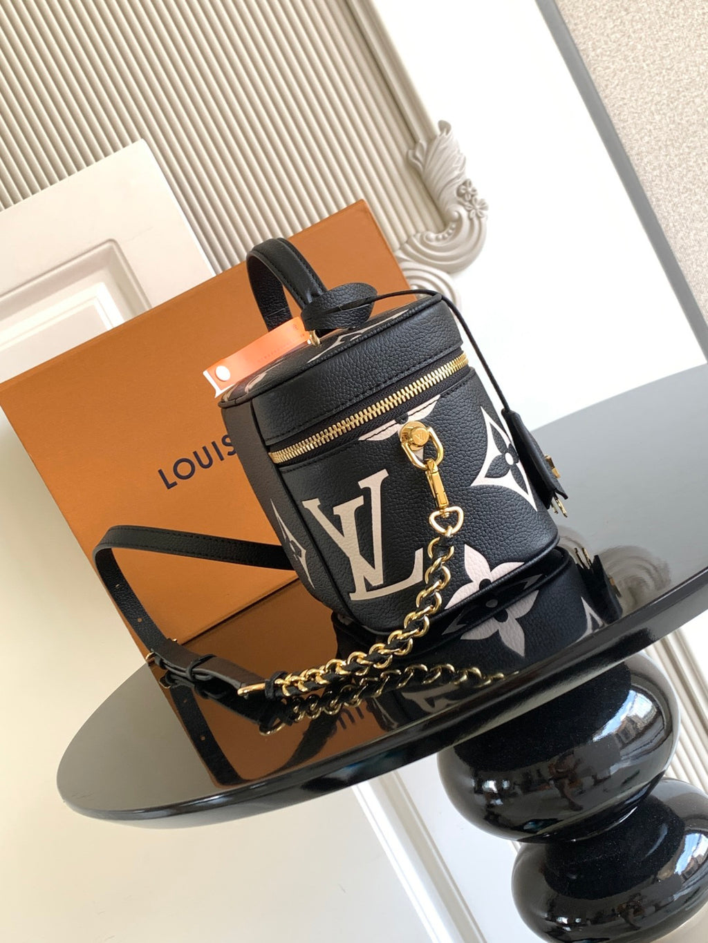 Louis Vuitton mini crossbody bag in black with white monogram, gold zipper and chain