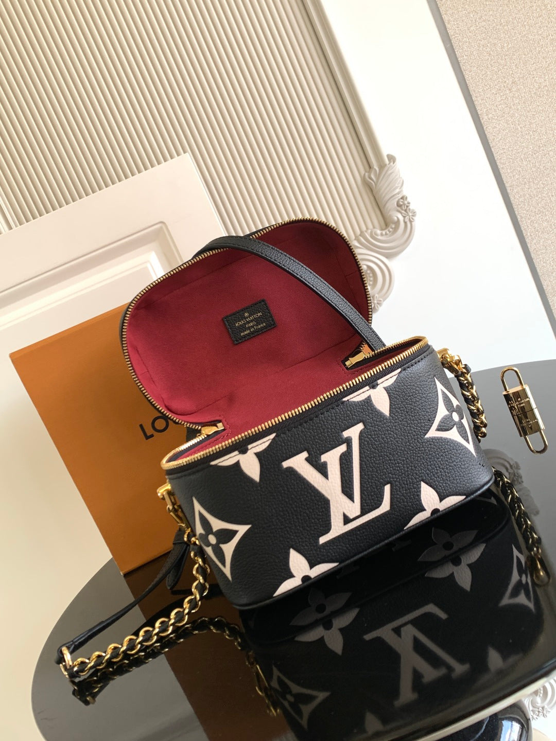 Louis Vuitton mini bag with black monogram exterior and red fabric-lined interior