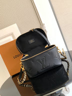 Black Louis Vuitton mini crossbody bag with flap top, chain strap, and gold hardware