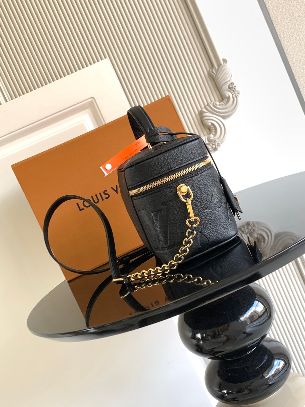 Black Louis Vuitton monogram crossbody bag with front zipper pocket and gold chain strap