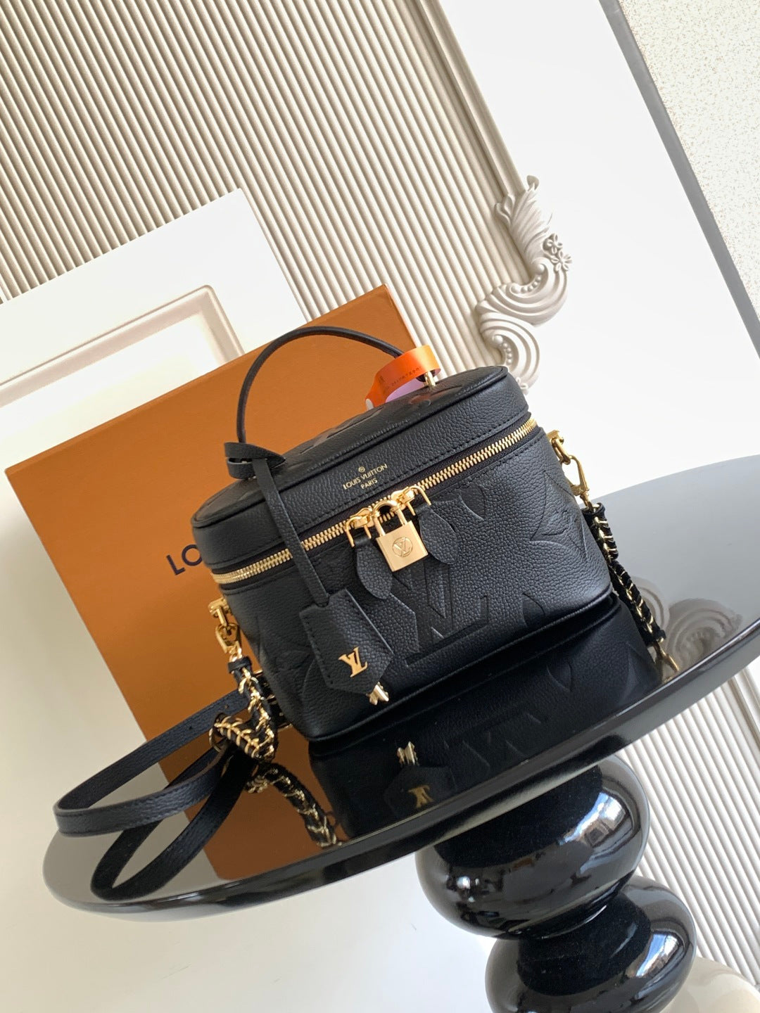 Black Louis Vuitton monogram crossbody bag with chain strap and gold zipper hardware