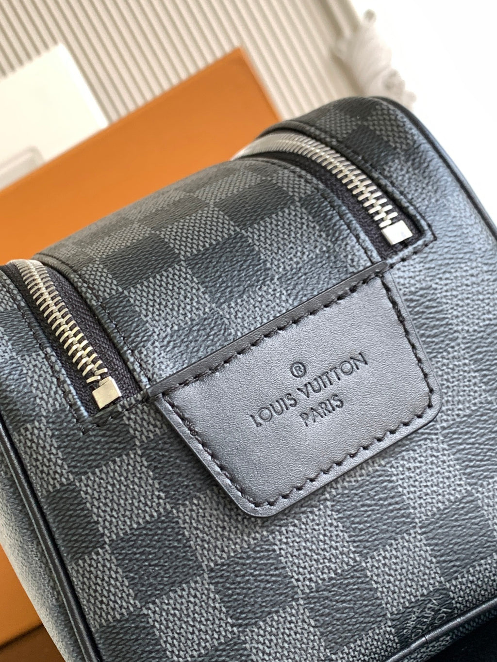 Louis Vuitton Damier checkered pouch with logo patch and metal zipper hardware