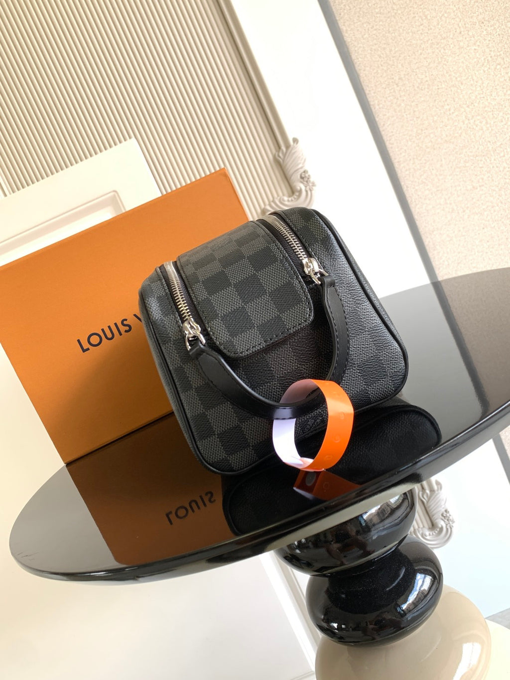 Louis Vuitton crossbody bag with dark Damier check pattern, top handle and strap