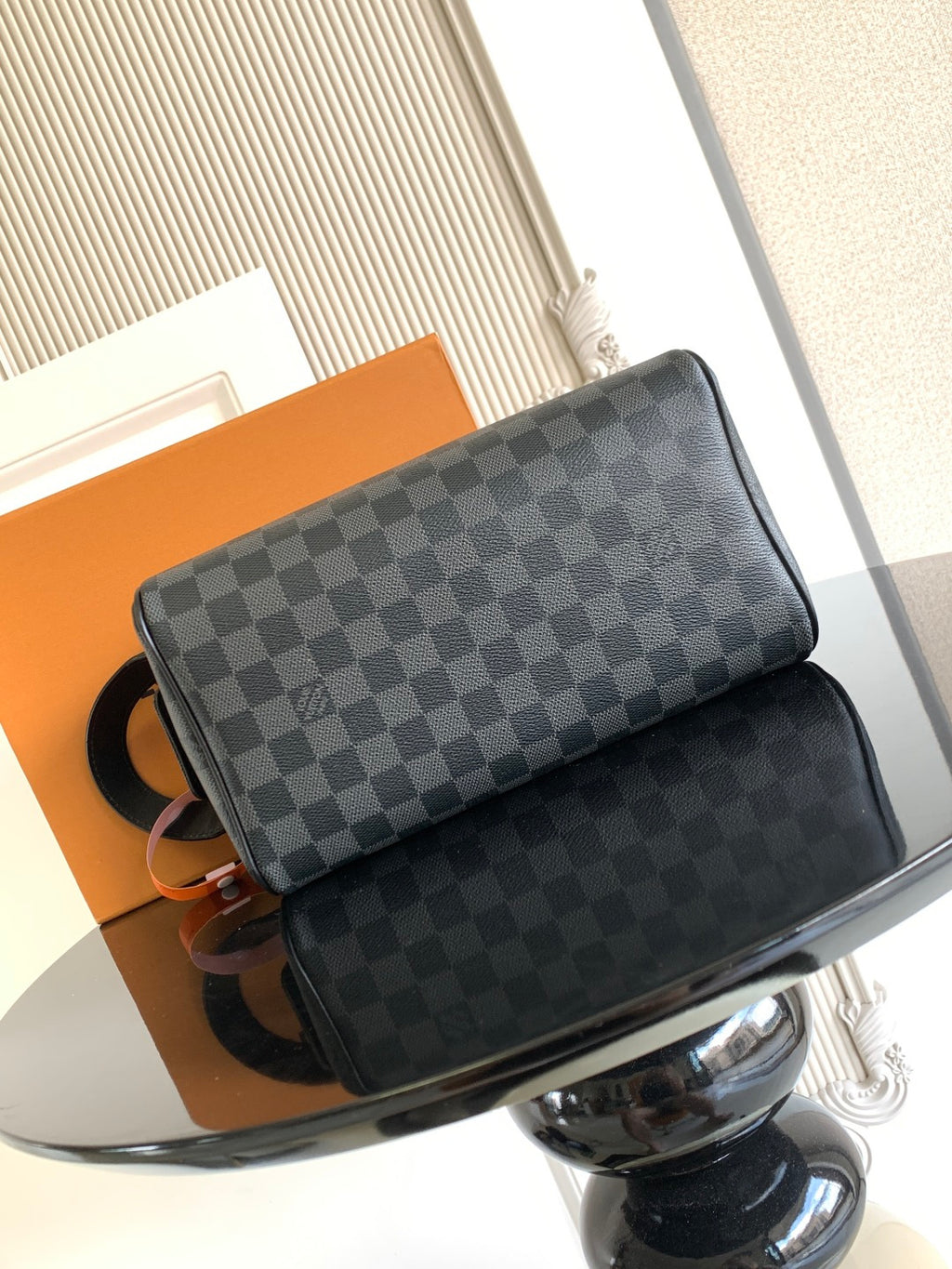 Louis Vuitton crossbody bag with dark Damier checkered front and black leather pocket