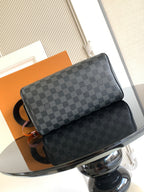Louis Vuitton crossbody bag with dark Damier checkered front and black leather pocket