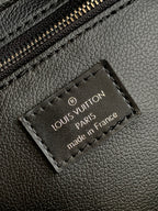 Louis Vuitton leather logo patch reading 'PARIS' and 'made in France' on black bag