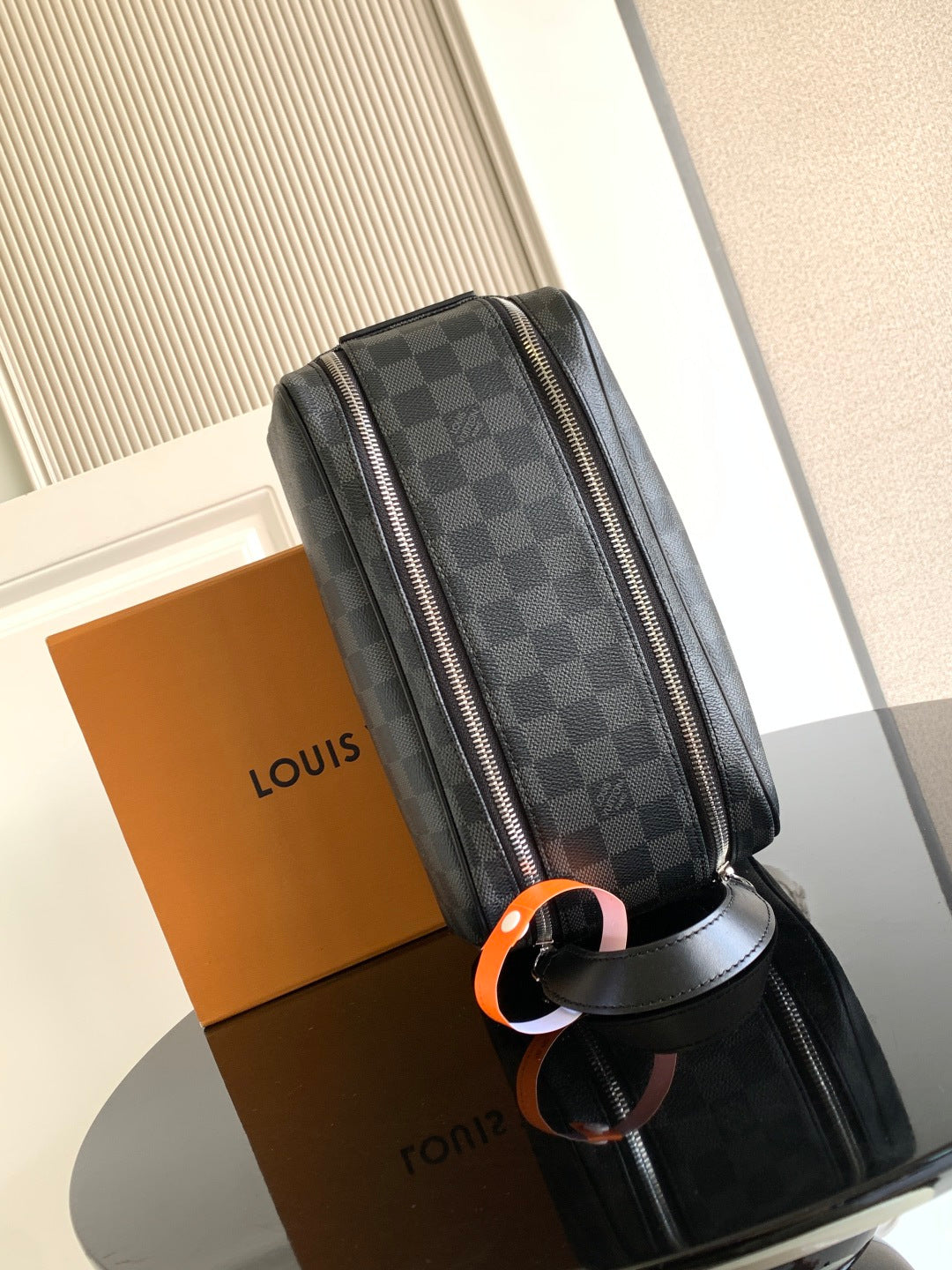 Louis Vuitton crossbody bag, vertical view with full-length zipper and Damier check pattern