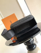 Louis Vuitton bag with black leather look, top zipper, and side strap detail