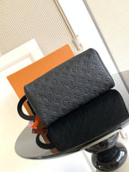 Louis Vuitton bag with dark monogram texture, ring strap, and orange hanging tag