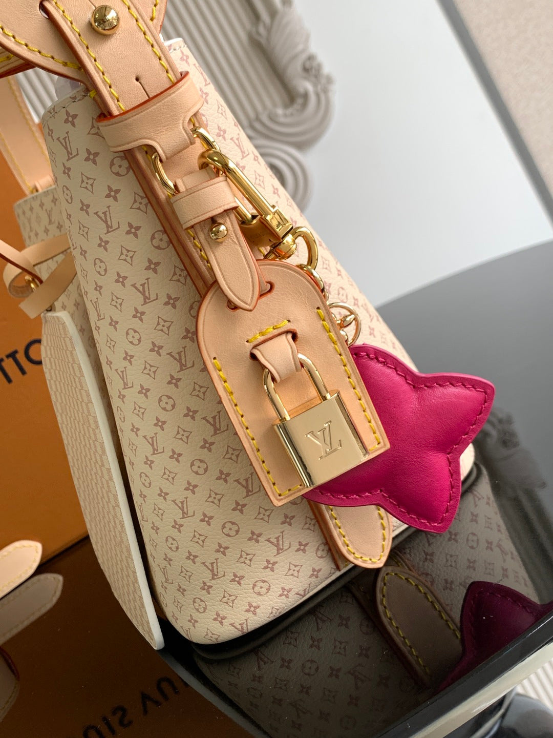 Louis Vuitton monogram tote with gold hardware, pink bow charm and tan leather straps